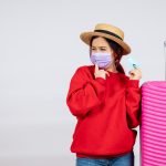 Proven Ways to Stay Safe, Healthy & Connected While Abroad 1 front view young female preparing trip mask white wall